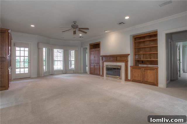 Live Large in Meadows West 8 Cozy family room with built-in cabinetry and fireplace