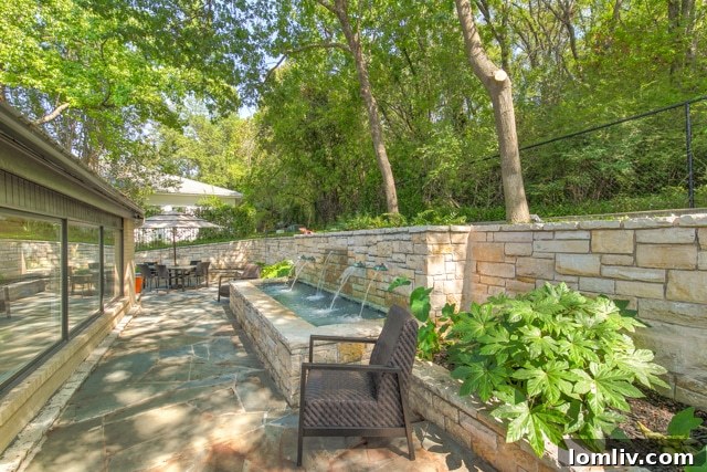 Serene reflection pond on a flagstone patio, creating tranquil sounds in an urban Fort Worth setting