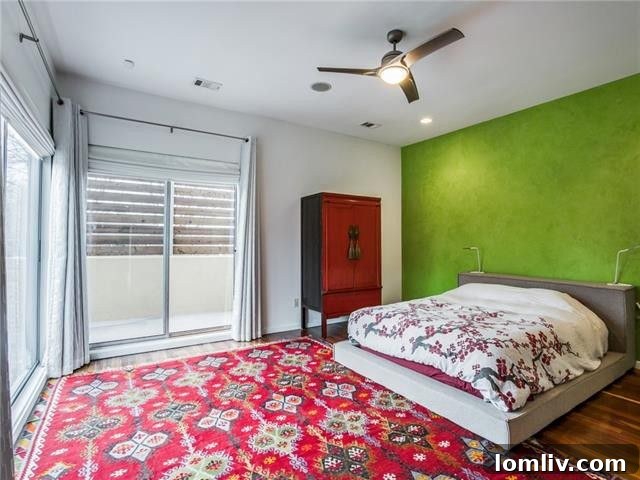Another view of a spacious bedroom, featuring ample natural light and clean design