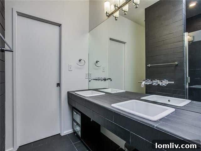 Chic vanity area with contemporary mirror and lighting in one of the bathrooms