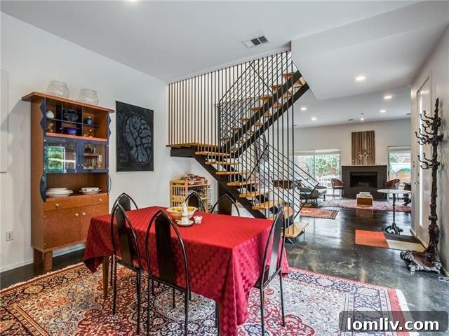 Elegant dining area with modern lighting and views of the industrial staircase