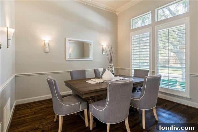 Spacious Dining Area with Crown Molding and Natural Light