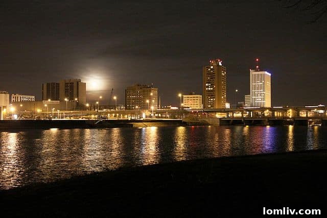 Downtown Cedar Rapids skyline with modern buildings and bridges over the Cedar River at sunset