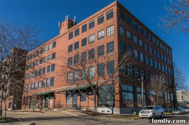 Modern industrial studio condo interior with large windows and an open floor plan