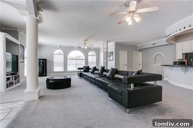 The spacious gameroom or 'man cave' equipped with its own full kitchen, providing an ideal space for entertainment or independent living at the Abrams Road residence.