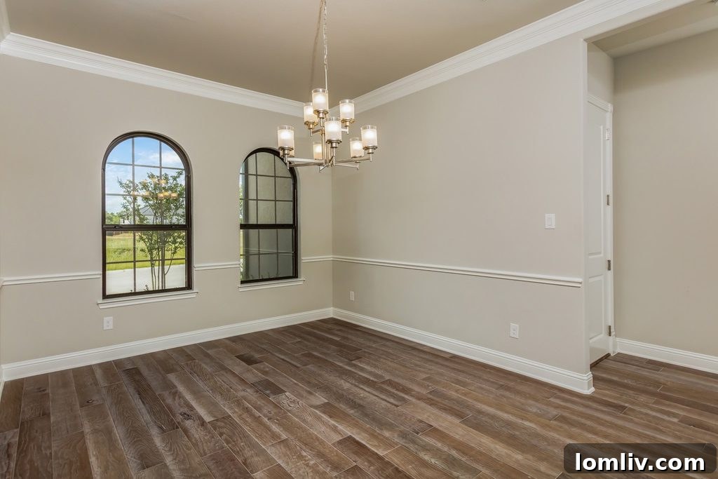 Luxurious open-concept living space with a grand staircase in a Westworth Falls home