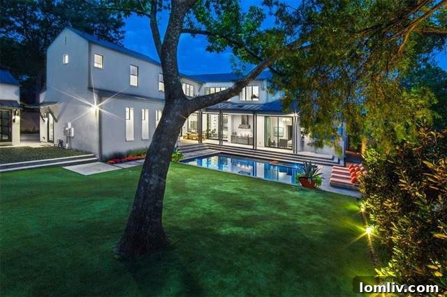 Lush backyard with synthetic turf, a refreshing pool, and a dedicated play area