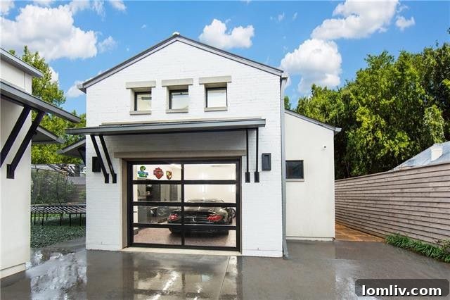 Spacious garage with epoxy flooring and dedicated storage, prepared for an auto lift