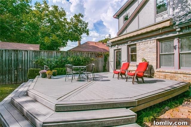 Private backyard oasis with an expansive deck and mature trees perfect for entertaining