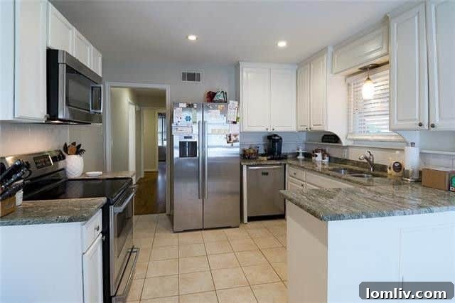 Modern kitchen with new tile flooring and appliances in Dallas rental home