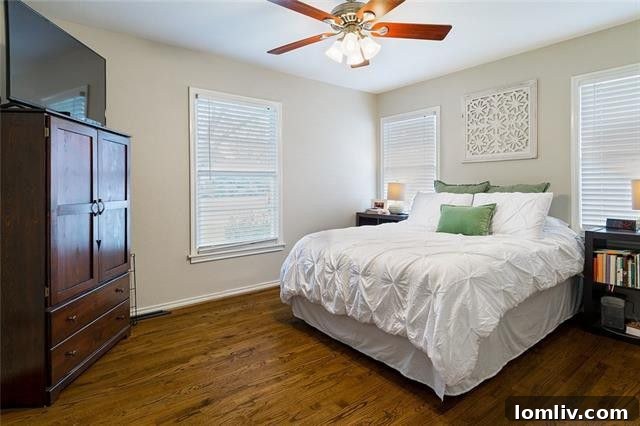 Bedroom with hardwood floors in renovated Midway Hollow rental