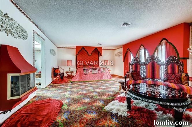 Psychedelic master bedroom with patterned carpet and multiple seating areas