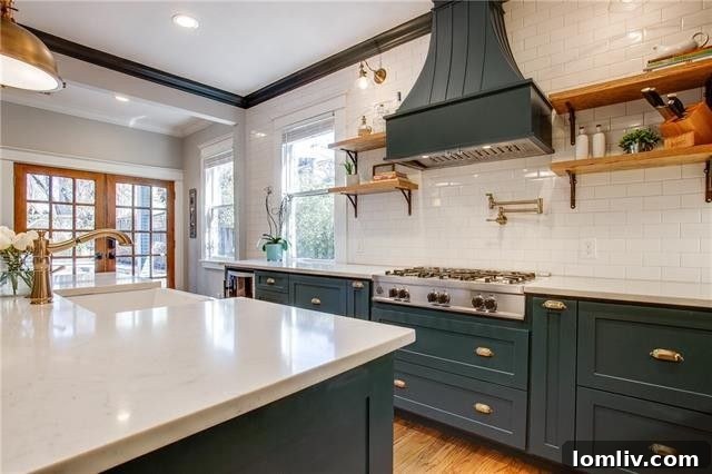 Luxurious, open-concept kitchen with quartz countertops and brass hardware in a renovated 1920s East Dallas home