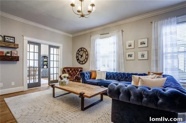 Elegant dining area with original hardwood floors and intricate moldings in a renovated Swiss Avenue home