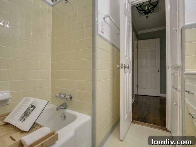 Charming vintage yellow Daltile adorning the hall bathroom, preserving original character and adding retro appeal