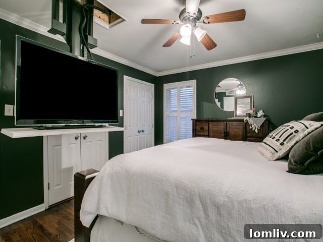 Master bedroom showcasing a television visibly suspended from the ceiling for entertainment