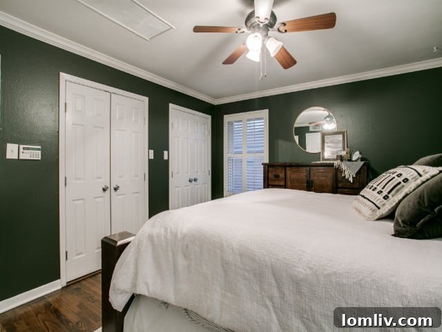Master bedroom with the television seamlessly retracted and hidden within the ceiling, maintaining a clean aesthetic