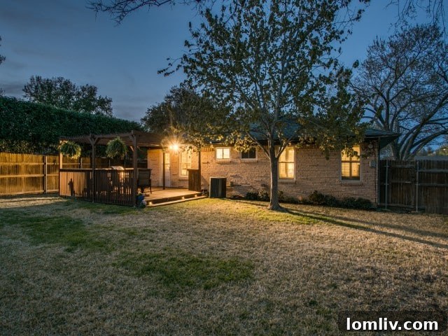 Lush and meticulously maintained garden area and green lawn in the spacious backyard of a Dallas ranch home