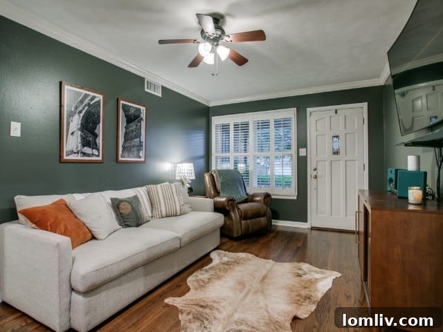 Bright and spacious living room featuring polished hardwood floors and elegant plantation shutters in 9017 Livenshire Dr
