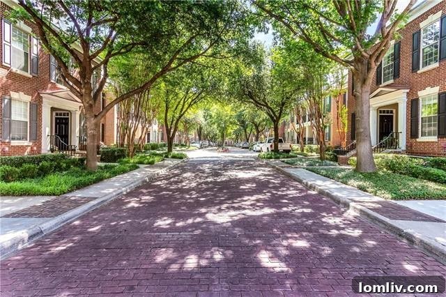 Lush green entrance to The Caruth luxury townhomes in Dallas, Texas