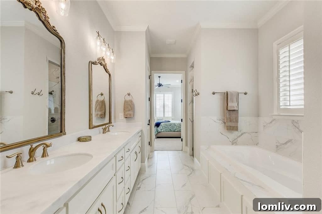 The luxurious master bathroom at 612 Rockledge Court, showcasing modern finishes, dual vanities, and a freestanding soaking tub.