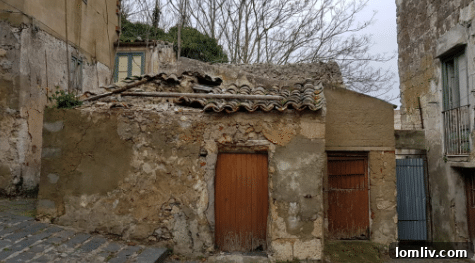 A rundown rooftop of an abandoned Mussomeli house, showing extreme disrepair