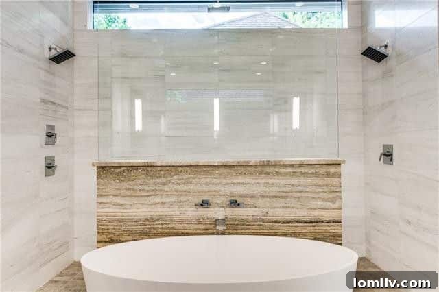 Bluffview's Finest Open Houses Limited Engagement 6 Luxurious master bathroom with a freestanding tub and designer fixtures.