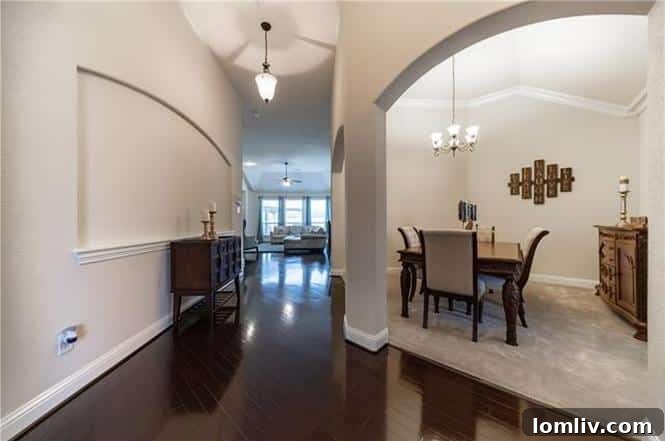 Spacious living room with dark hardwood floors and high ceilings