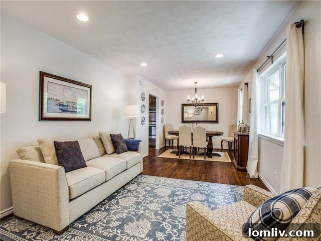Spacious and bright living room with large windows and a view to the backyard