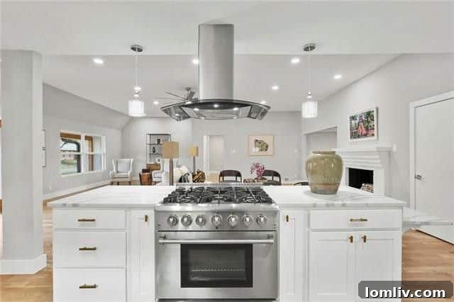 Modern quartz kitchen with island and pendant lighting in renovated Caruth Meadows house