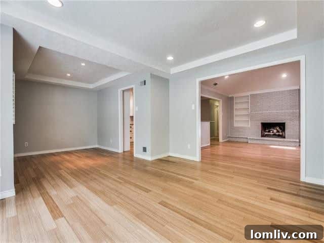 Inviting living room with wood floors, crown molding, and ample natural light