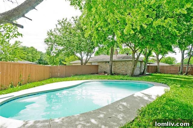 Inviting backyard with a sparkling swimming pool and covered patio