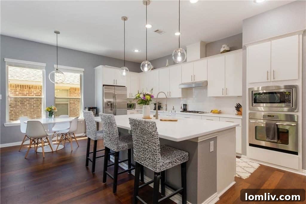 Bright and airy dining area with contemporary lighting and artwork