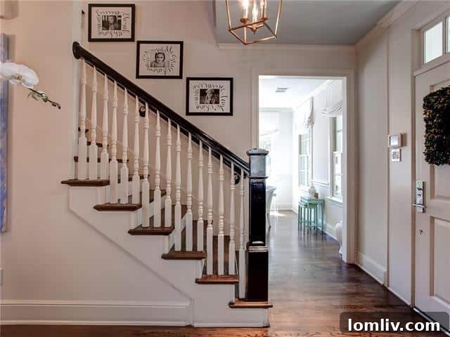 Elegant entryway of 2721 Manorwood Trail with rich oak hardwood floors and ebonized bannister