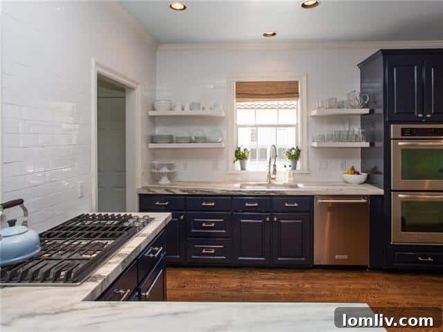 Gourmet kitchen at 2721 Manorwood Trail featuring white marble countertops and cobalt blue cabinetry