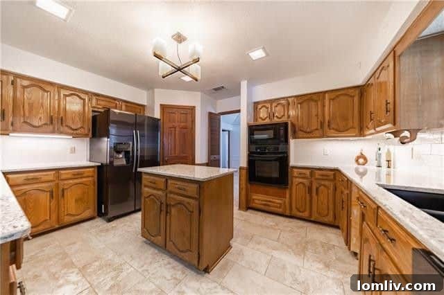 Kitchen with new granite countertops and built-in wine cooler at 4505 Ivy Drive