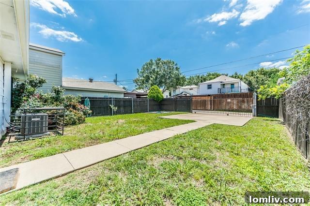 Lush Green Backyard with Privacy Fence and Gated Driveway