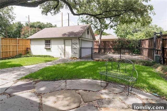 Private backyard with limestone patio and mature oak tree at 5651 Purdue Avenue