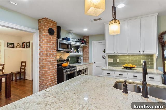 Modern kitchen with granite countertops and exposed brick wall