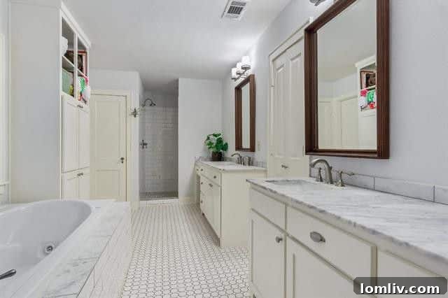 Luxurious master bathroom with penny tile and marble finishes