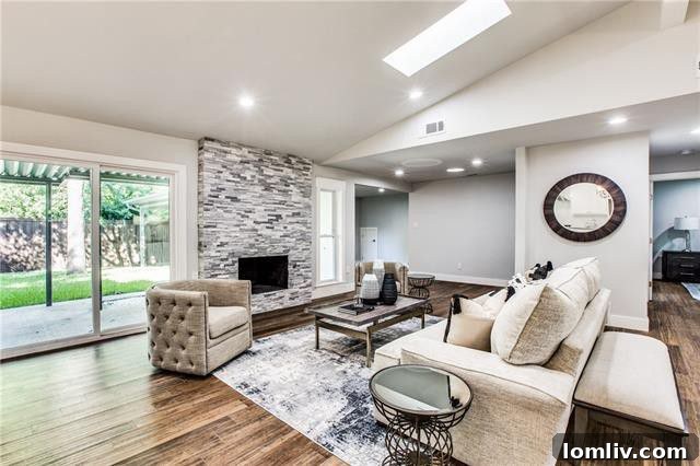 Bright and open concept living room with vaulted ceilings.