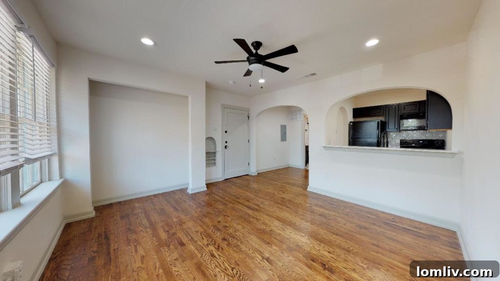 Efficiency unit interior at Bella Villa highlighting historic features like a telephone nook and arched entryways in Dallas.