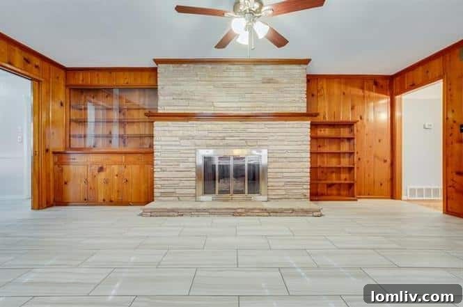 Cozy Living Room with Original Wood Paneling and Stacked-Stone Fireplace