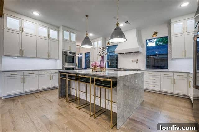 High-end gourmet kitchen with marble island and custom cabinetry