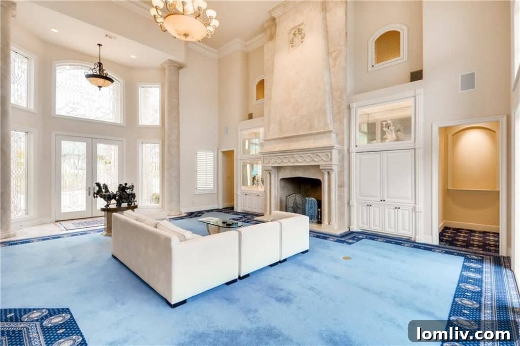 Grand living room with high ceilings, fireplace, and lake views at 1901 Park Street