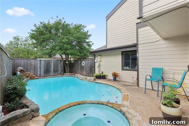 Heated Pool and Spa with Rock Water Feature in Backyard