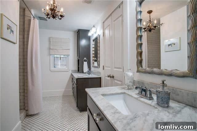 Luxurious master bathroom with Carrera marble finishes at 6103 Hudson Street.