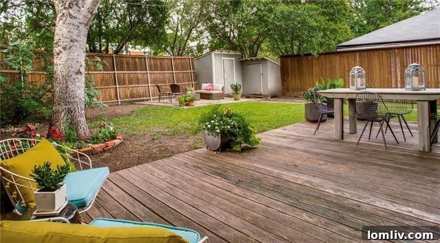 Spacious backyard deck and patio area with an 8-foot privacy fence at 6103 Hudson Street.