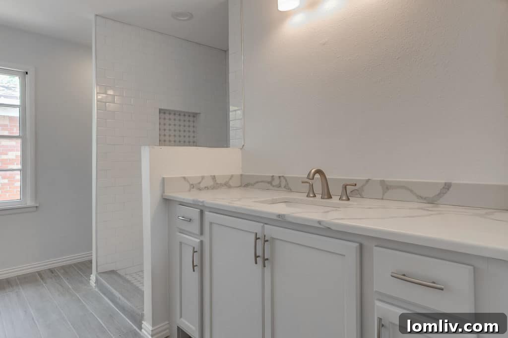 Modern bathroom renovation at 5504 Santa Barbara, featuring a large shower and trendy materials.
