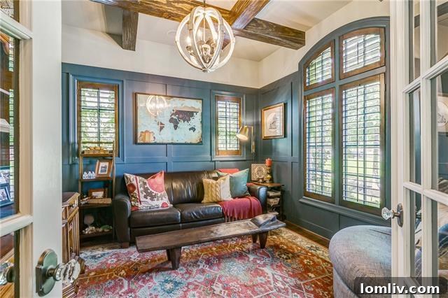 Charming study with Williamsburg Blue paneled walls and a classic beamed ceiling, perfect for a home office or library